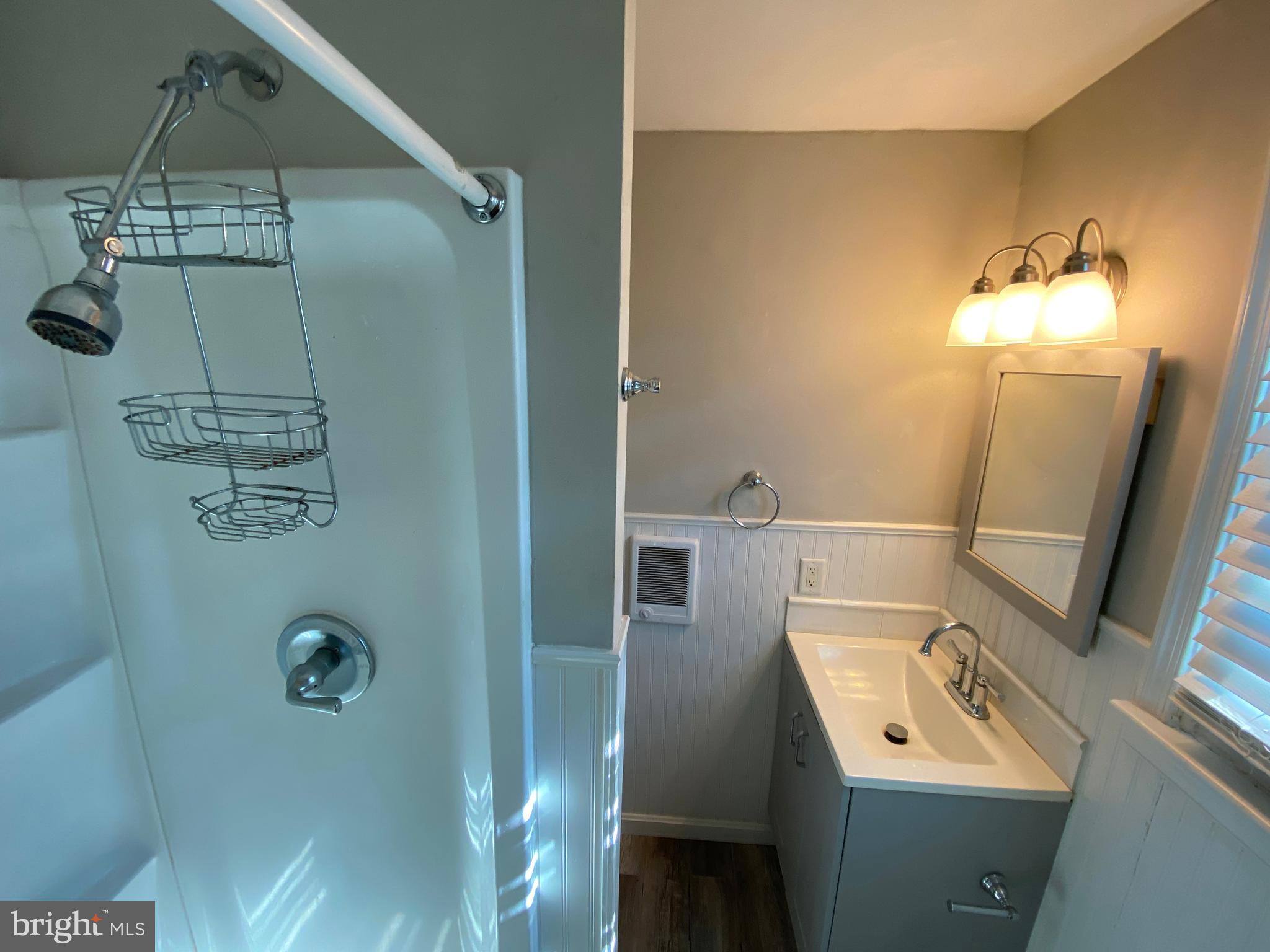 205 North Irving Avenue Colonial Beach, VA 22443 - Photo 16 of 22 a bathroom with a sink mirror and toilet