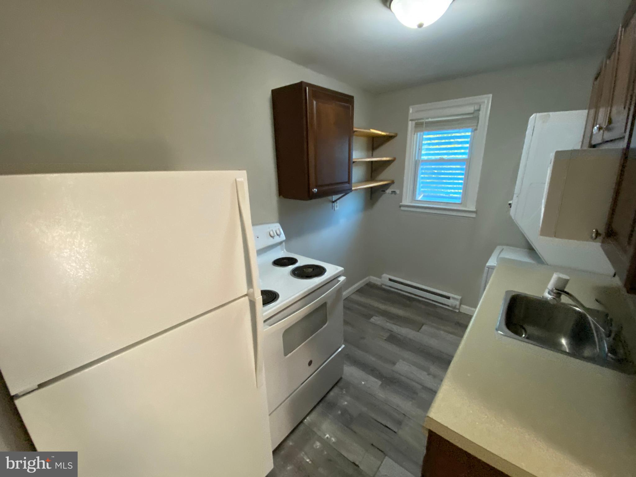 205 North Irving Avenue Colonial Beach, VA 22443 - Photo 17 of 22 a kitchen with a refrigerator and a stove