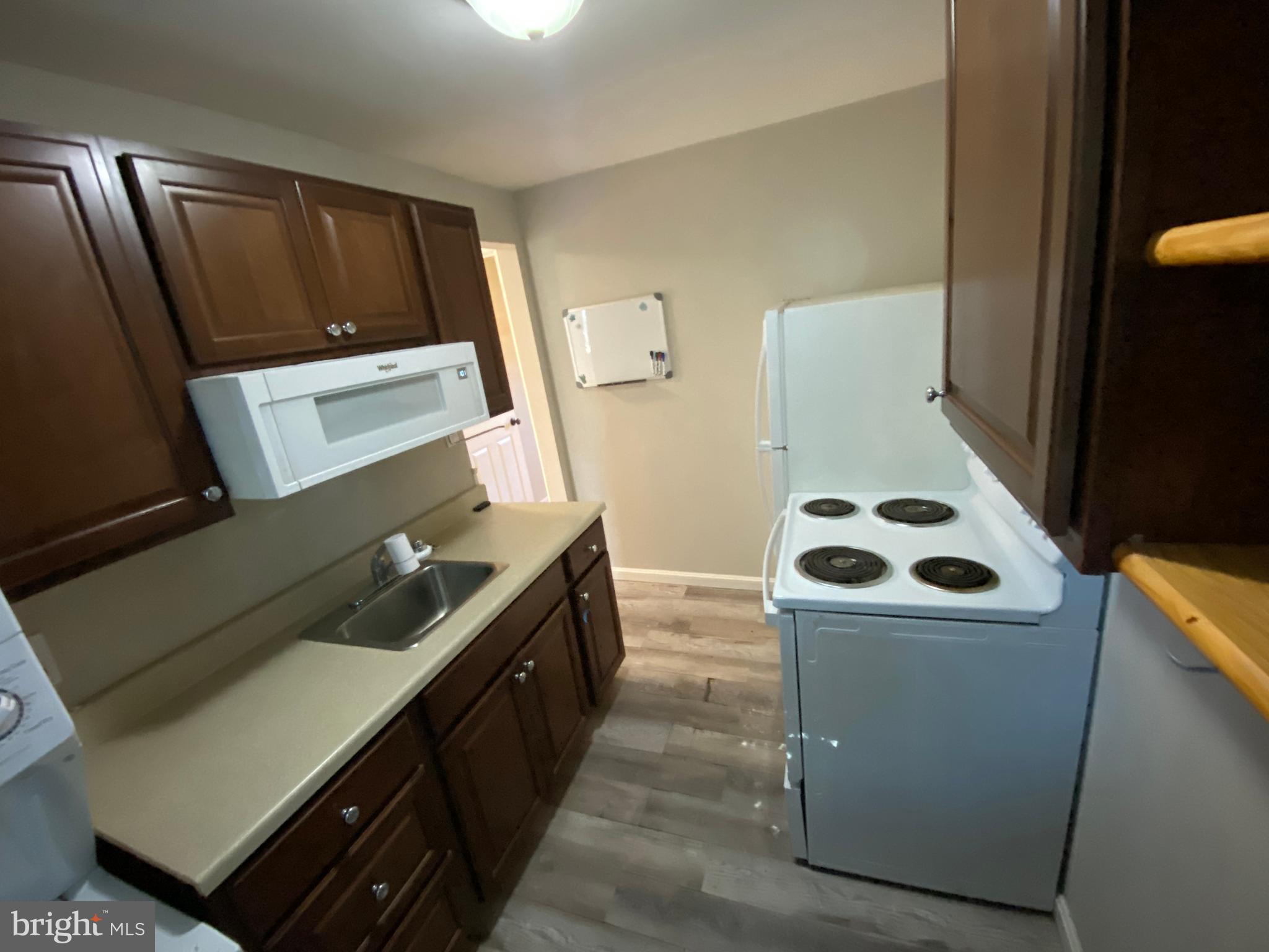 205 North Irving Avenue Colonial Beach, VA 22443 - Photo 18 of 22 a kitchen with a refrigerator and a stove