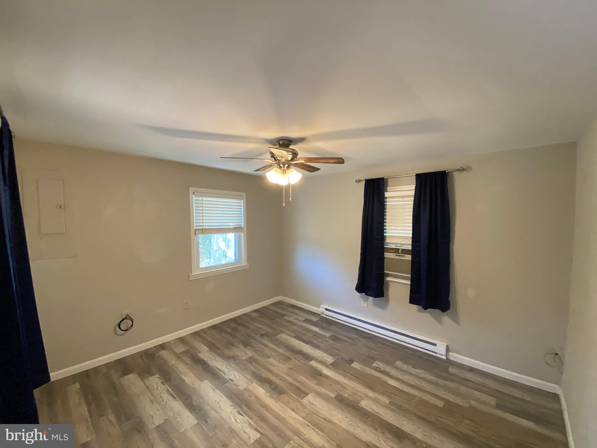 205 North Irving Avenue Colonial Beach, VA 22443 - Photo 7 of 22 a view of an empty room with window and chandelier fan