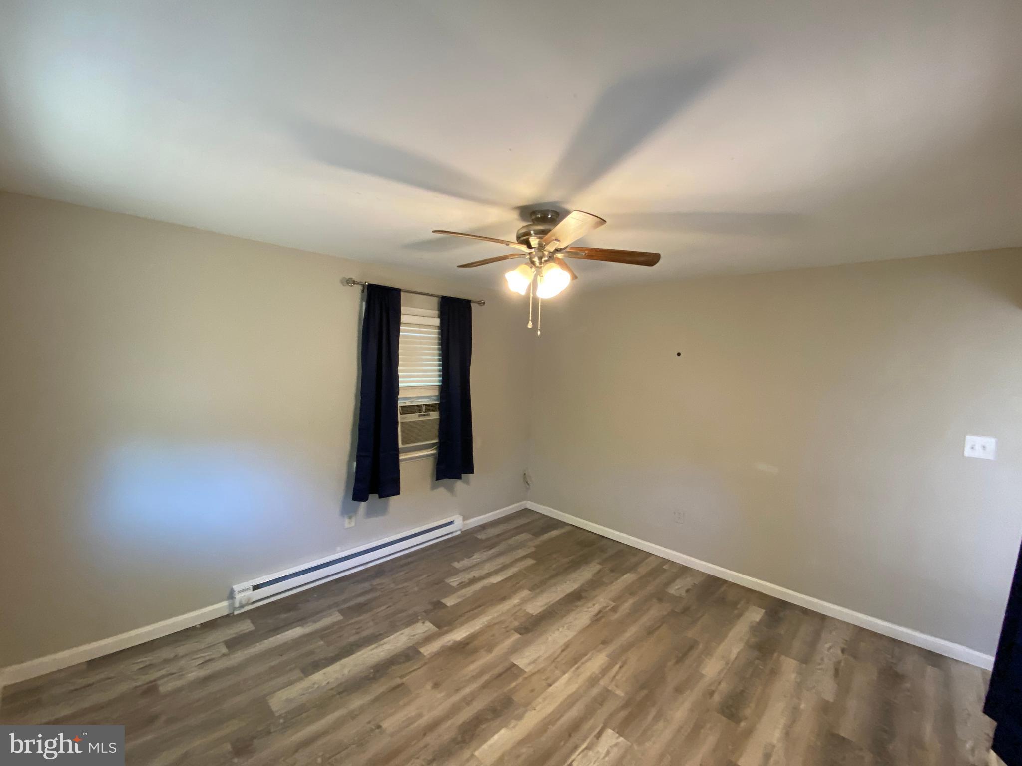205 North Irving Avenue Colonial Beach, VA 22443 - Photo 10 of 22 wooden floor in an empty room
