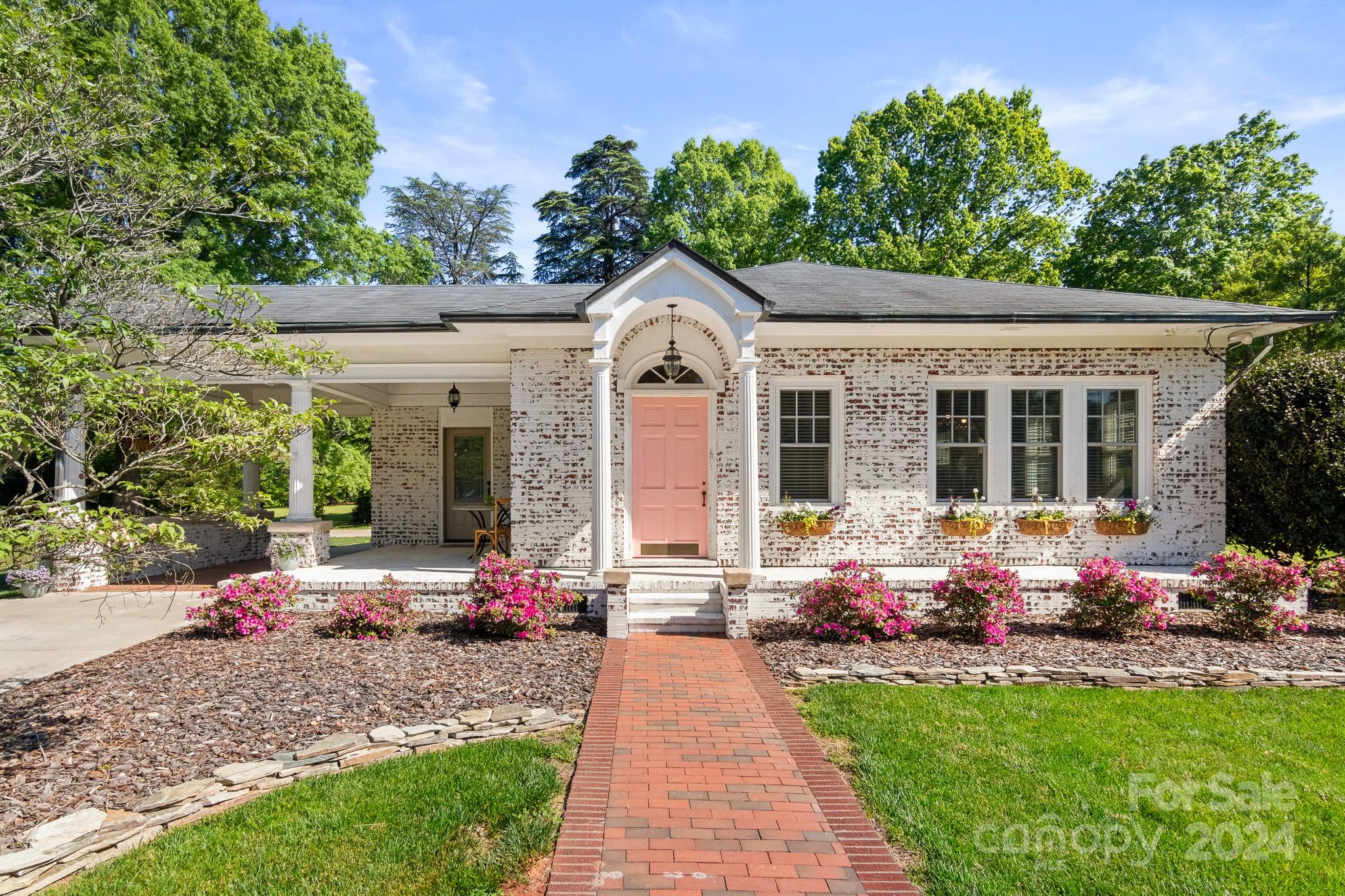 a front view of a house with garden