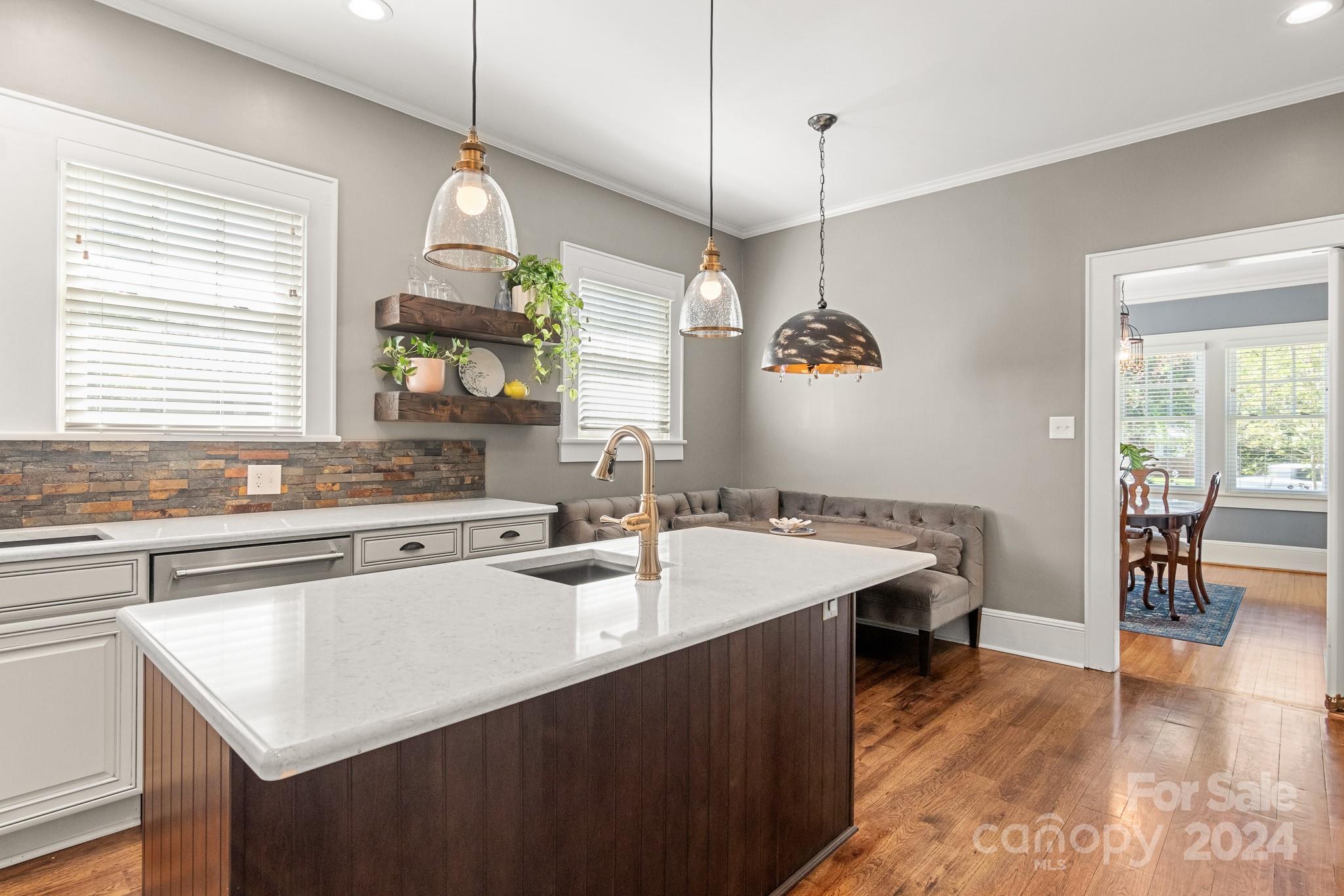 221 Ridgeway Avenue Statesville, NC 28677 - Photo 11 of 45 a kitchen with a sink a window and chairs
