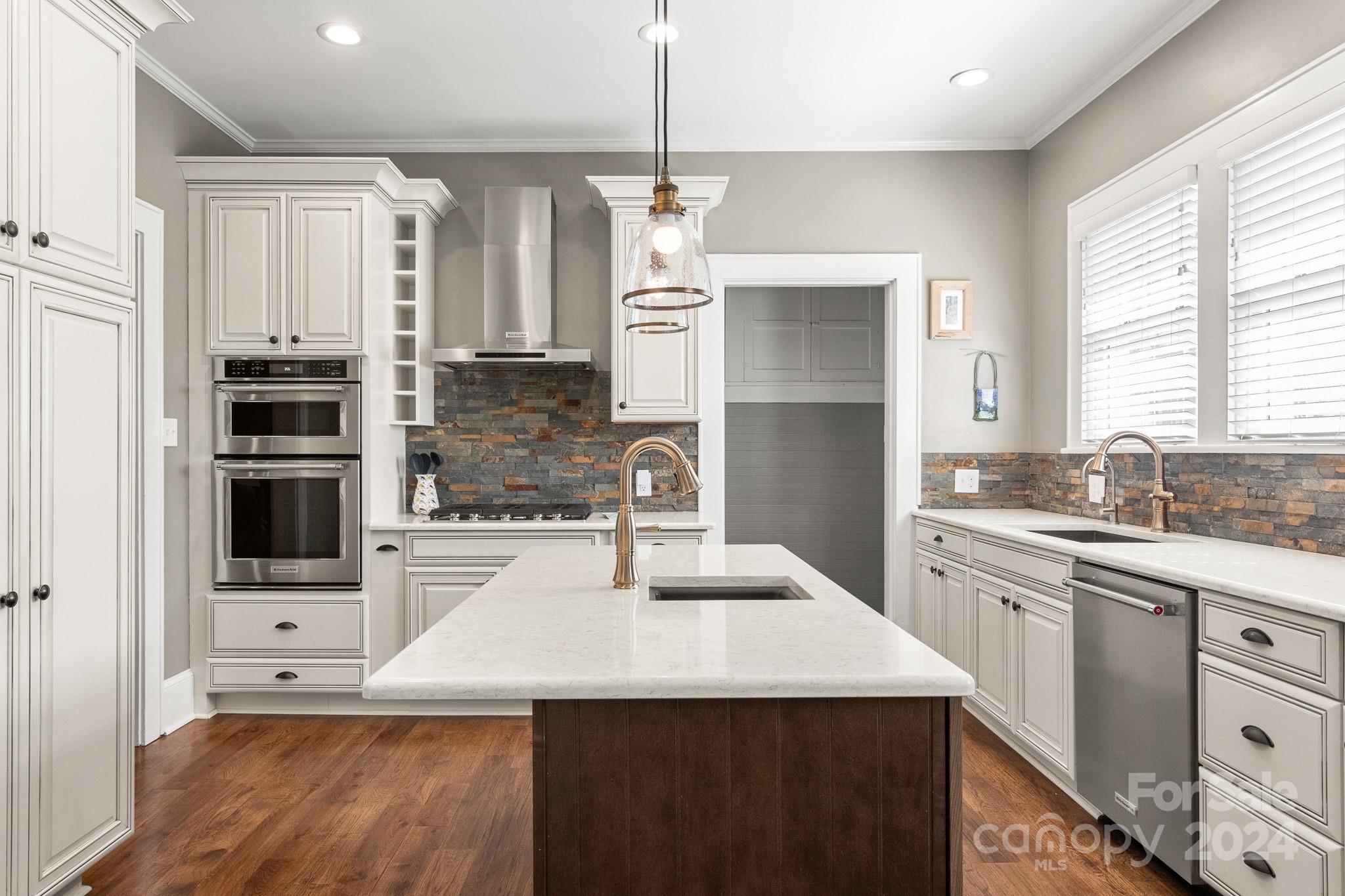 221 Ridgeway Avenue Statesville, NC 28677 - Photo 13 of 45 a kitchen with stainless steel appliances kitchen island granite countertop a refrigerator a sink dishwasher and white cabinets with wooden floor