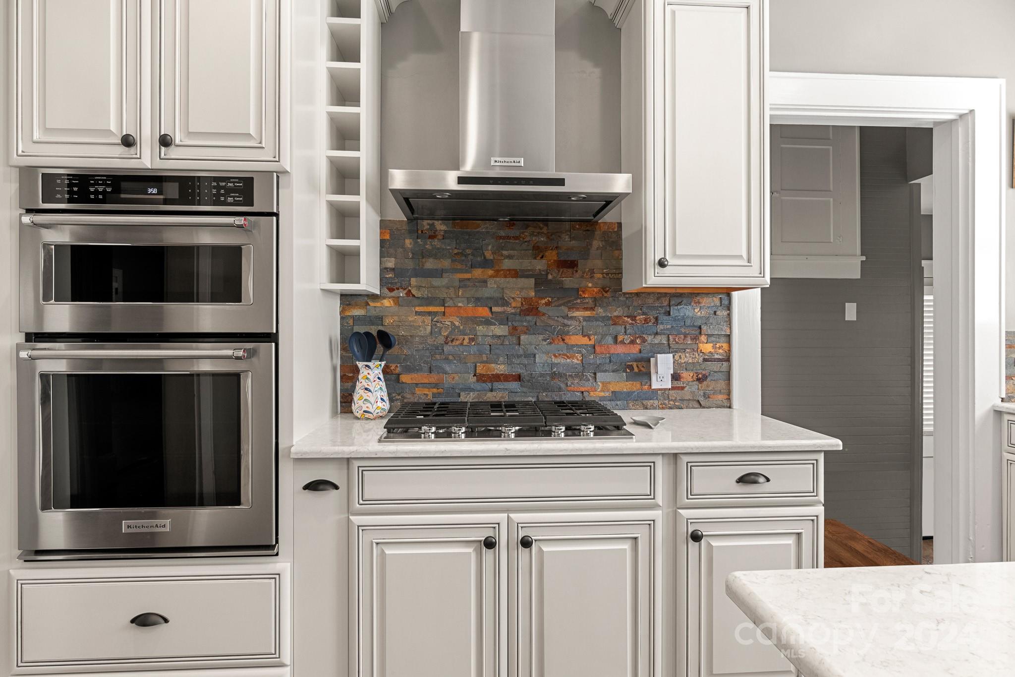 221 Ridgeway Avenue Statesville, NC 28677 - Photo 17 of 45 a kitchen with granite countertop white cabinets and stainless steel appliances