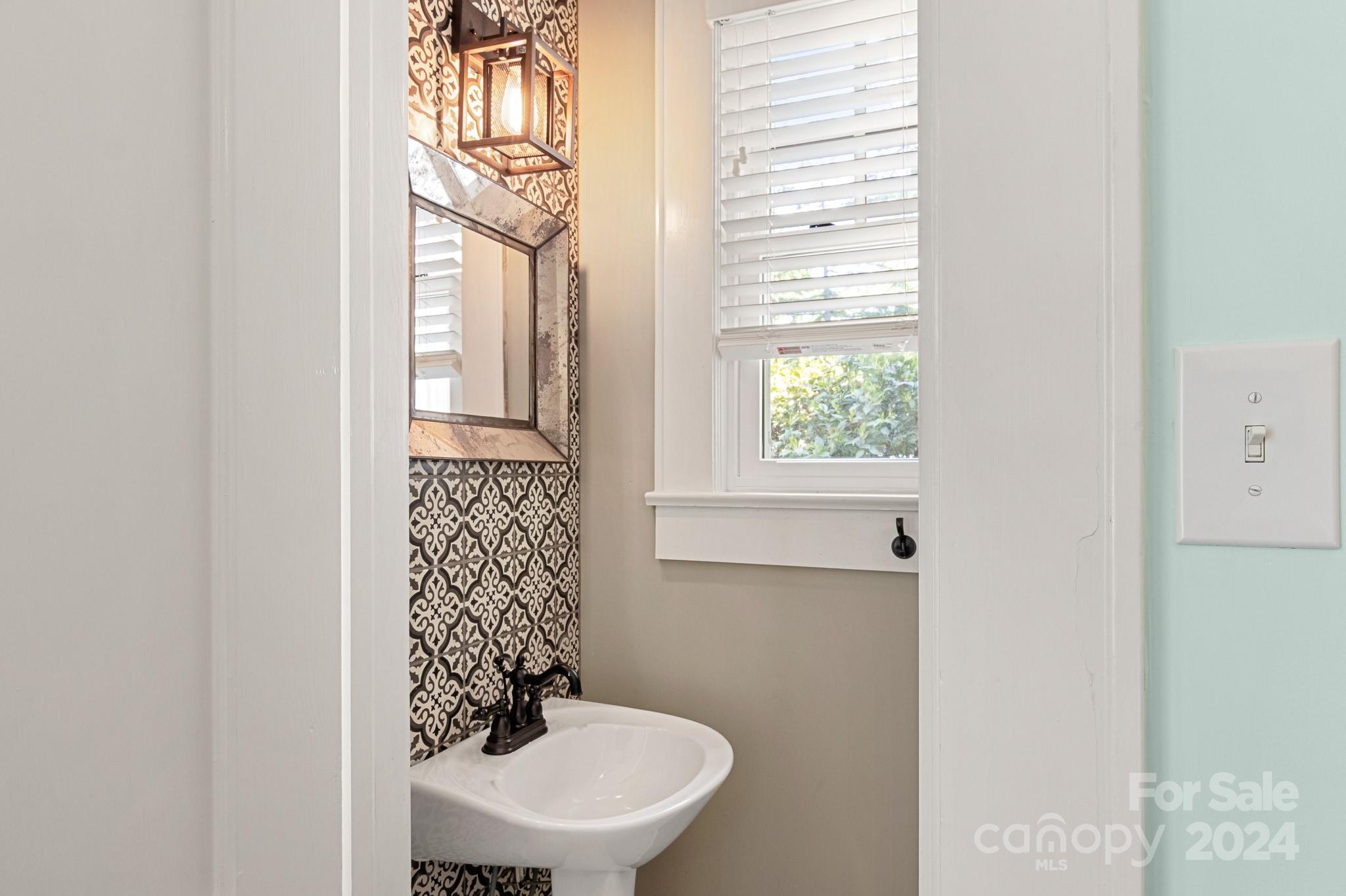 221 Ridgeway Avenue Statesville, NC 28677 - Photo 21 of 45 a bathroom with a sink a toilet and a window