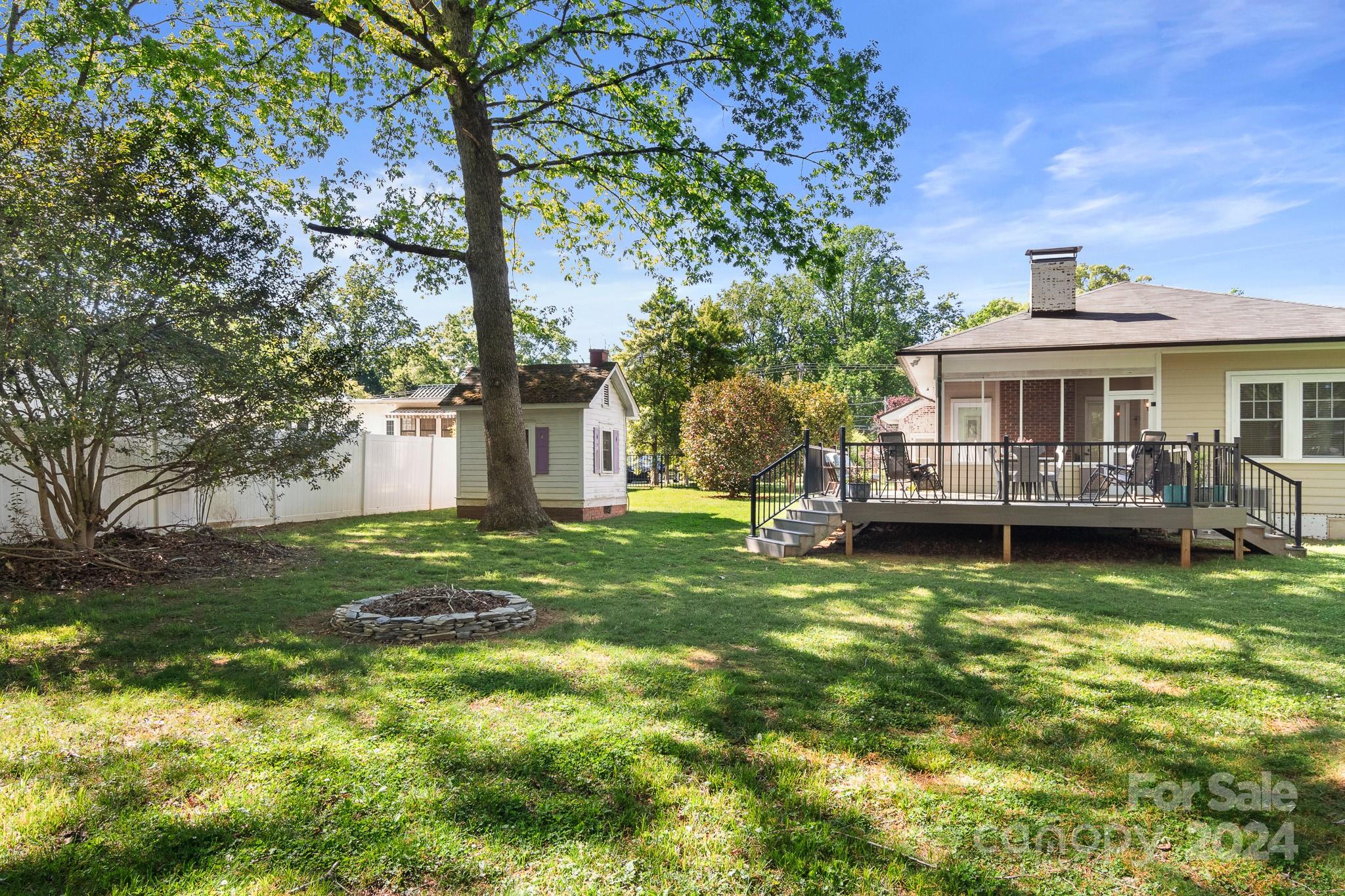221 Ridgeway Avenue Statesville, NC 28677 - Photo 42 of 45 a view of a house with a yard table and chairs