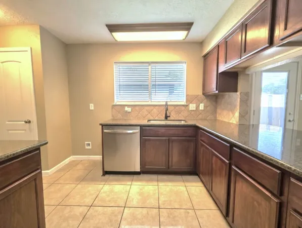 a kitchen with a sink and large window