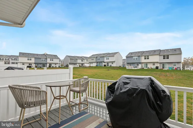 a view of a balcony with two chairs and a table
