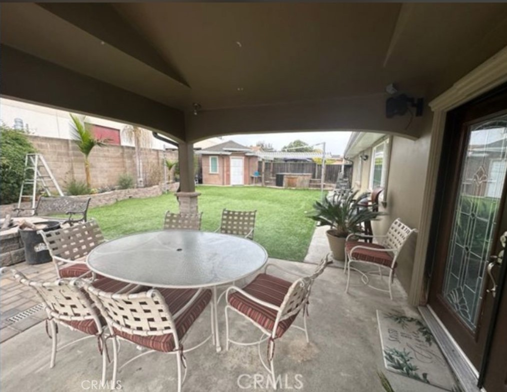48 Jeanette Way Watsonville, CA 95076 - Photo 13 of 14 a view of a patio with table and chairs potted plants and floor to ceiling window
