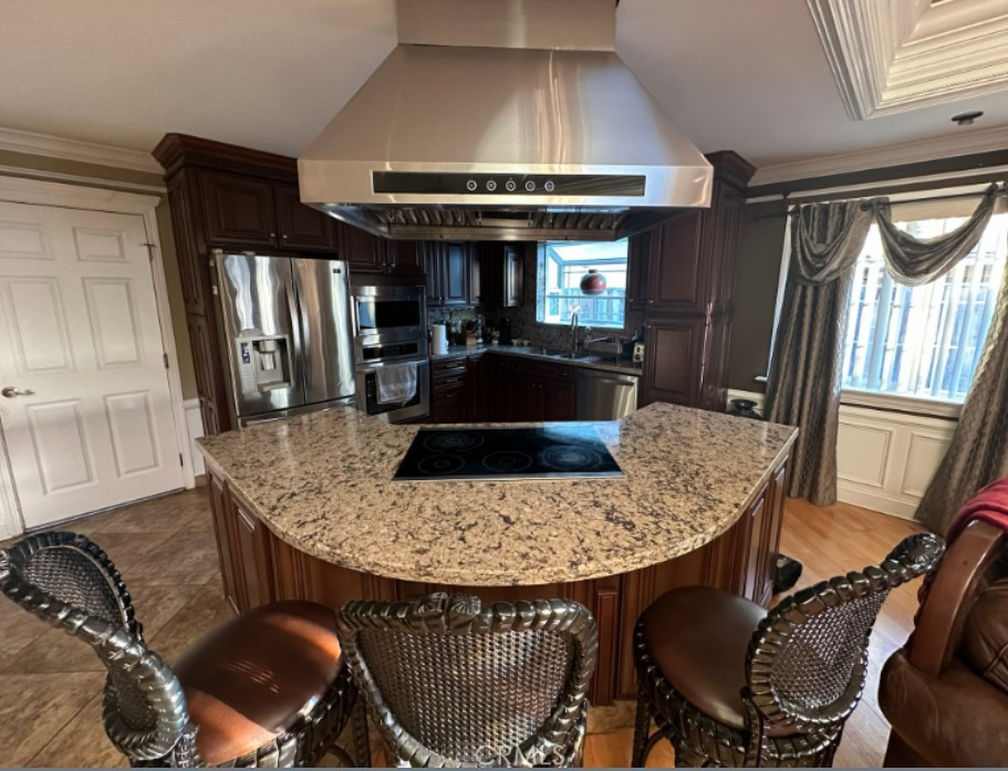 48 Jeanette Way Watsonville, CA 95076 - Photo 3 of 14 a kitchen with a table chairs and a refrigerator