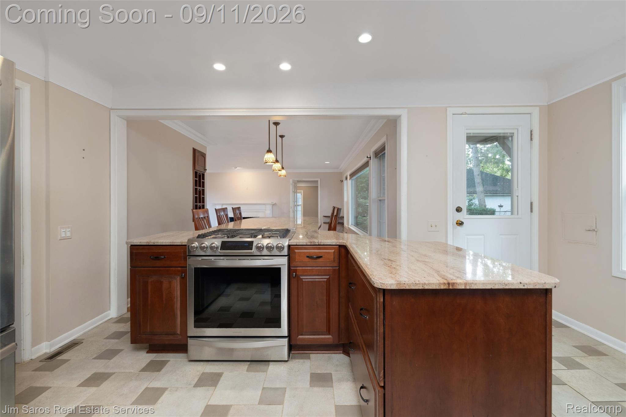 1445 Devonshire Road Grosse Pointe, MI 48230 - Photo 8 of 30 Kitchen featuring a stainless steel range, granite countertops, wood cabinetry, recessed lighting, and a patterned tile floor