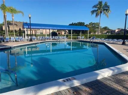 a swimming pool with outdoor seating and yard