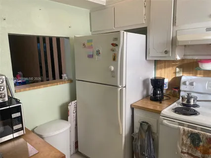 a view of a livingroom with workspace and a window