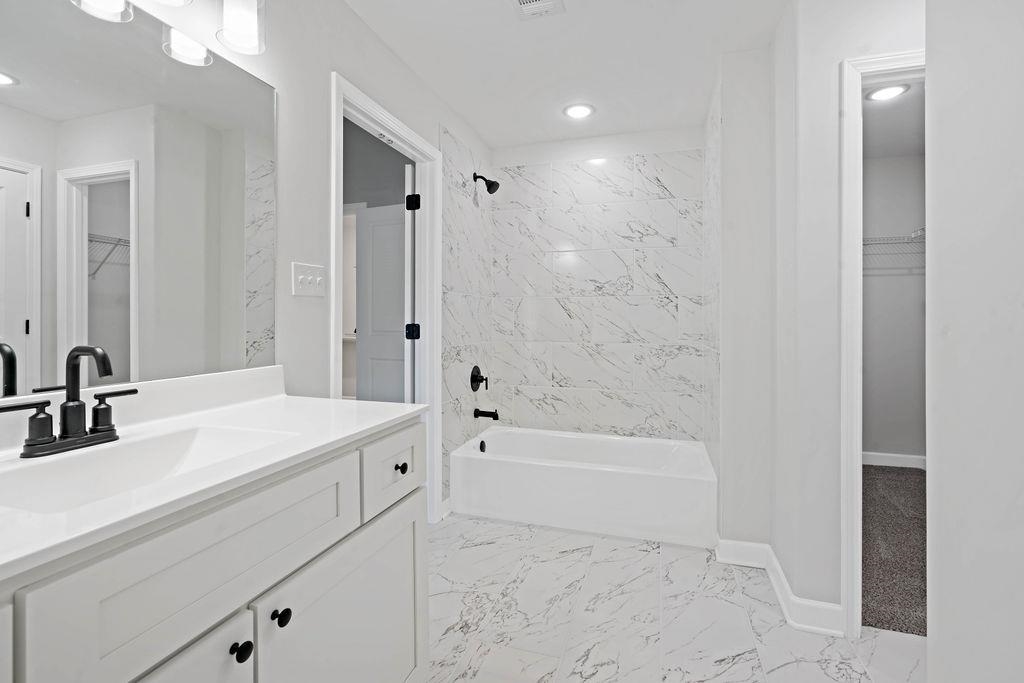 372 Edith Avenue Memphis, TN 38126 - Photo 13 of 23 Full bath featuring a walk in closet, shower / bath combination, vanity, light marble finish floors, and recessed lighting