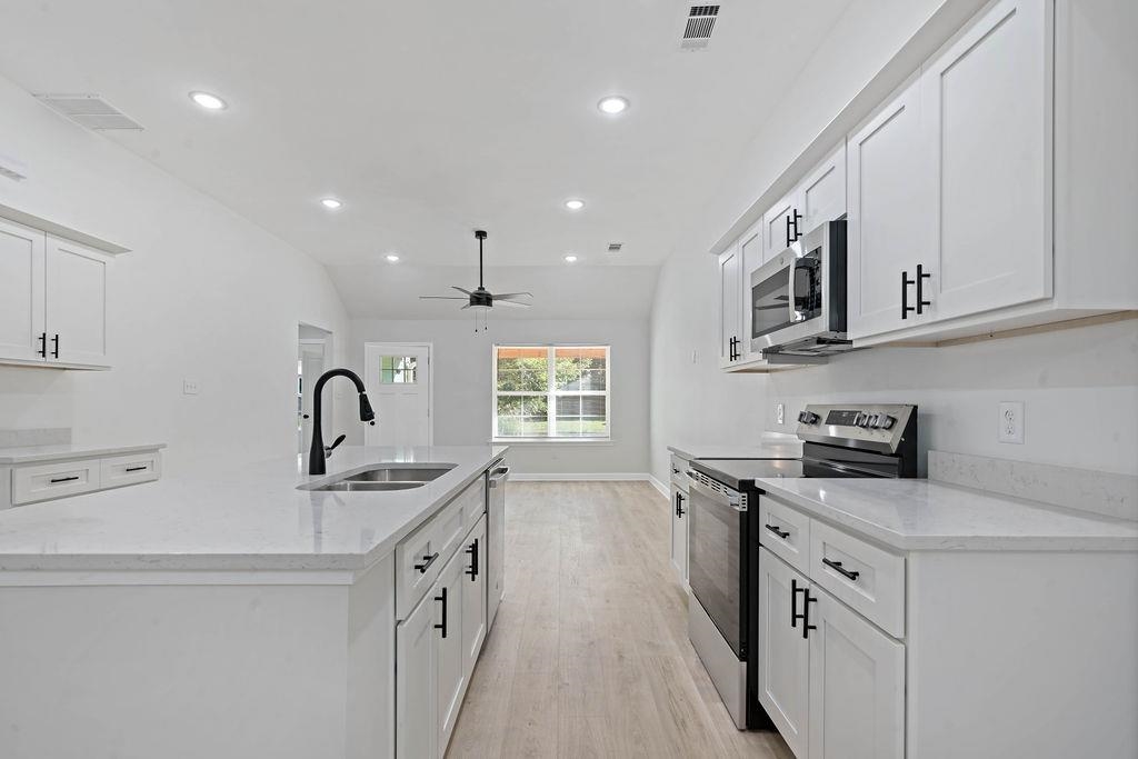372 Edith Avenue Memphis, TN 38126 - Photo 20 of 23 Kitchen with stainless steel appliances, white cabinets, light stone countertops, light wood-style floors, and recessed lighting