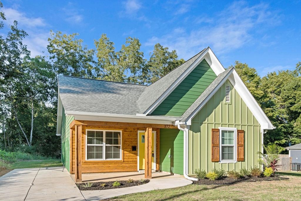 372 Edith Avenue Memphis, TN 38126 - Photo 3 of 23 Bungalow with roof with shingles, covered porch, board and batten siding, and a front yard