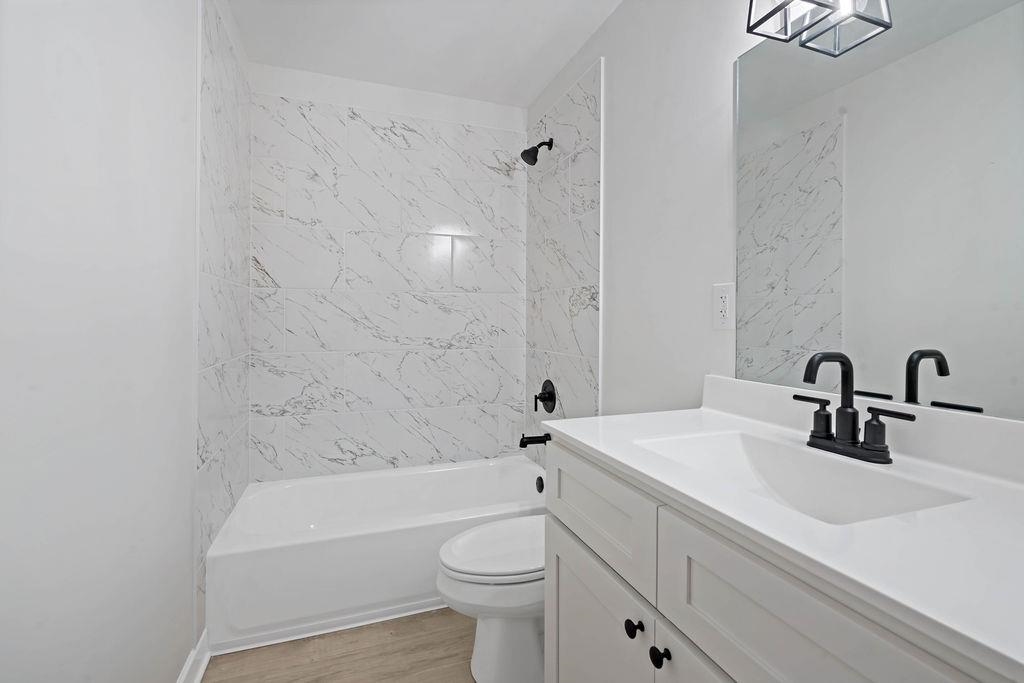 372 Edith Avenue Memphis, TN 38126 - Photo 8 of 23 Bathroom with bathtub / shower combination, vanity, and light wood-style flooring
