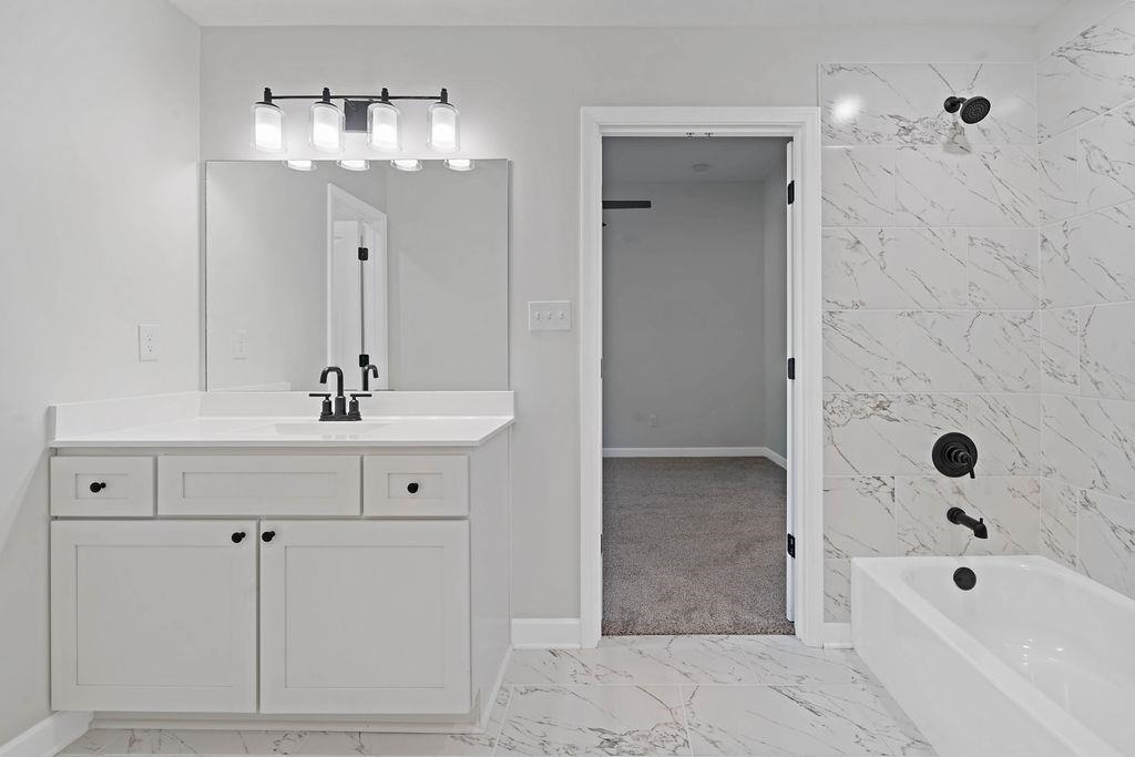 372 Edith Avenue Memphis, TN 38126 - Photo 10 of 23 Full bath featuring light marble finish floors, vanity, and shower / washtub combination