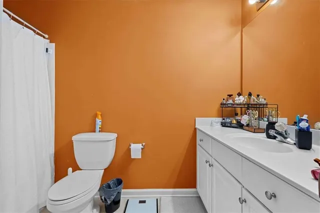 a bedroom with a bed and a flat tv screen on the dresser