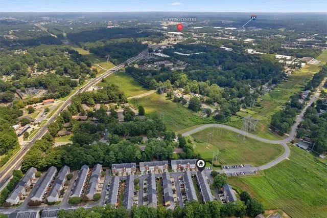 a aerial view of a house with a yard and potted plants