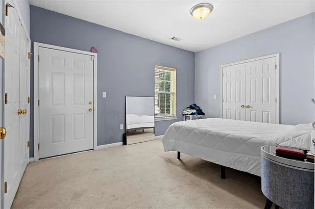 a bedroom with a bed and a closet