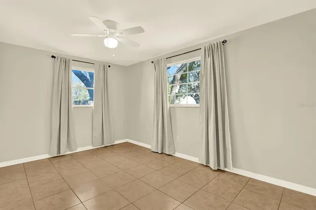 an empty room with windows and closet