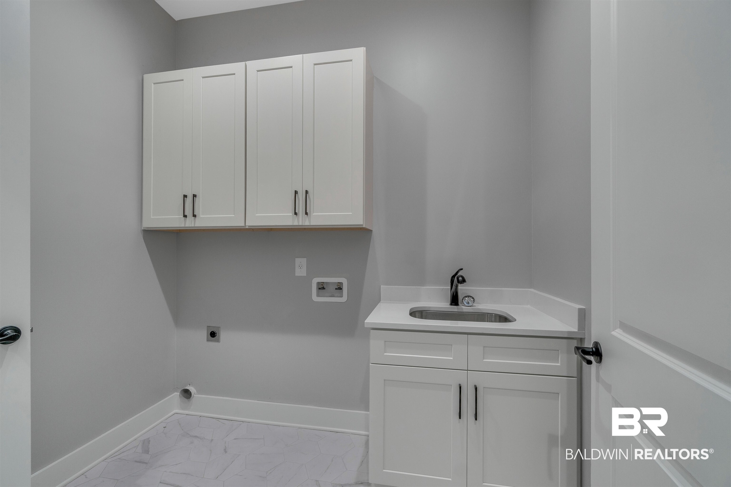 10985 Atrium Avenue Fairhope, AL 36532 - Photo 30 of 58 Laundry area featuring cabinet space, light marble finish floors, electric dryer hookup, and washer hookup
