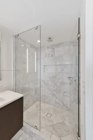 a bathroom with a shower and a sink