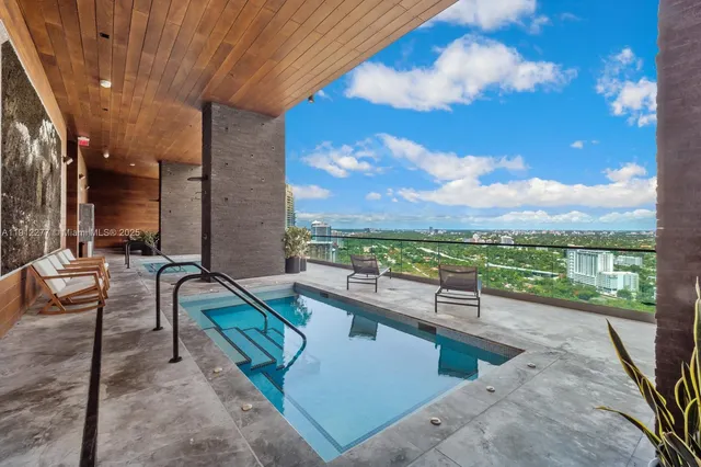 a view of a swimming pool with a lounge chairs