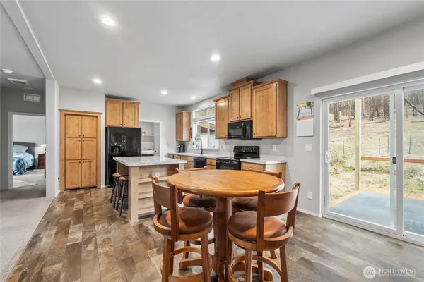 a dining room with furniture and a kitchen