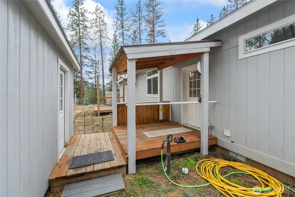 a backyard of a house with barbeque oven table and chairs