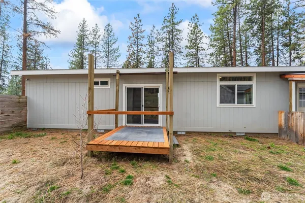 a backyard of a house with table and chairs