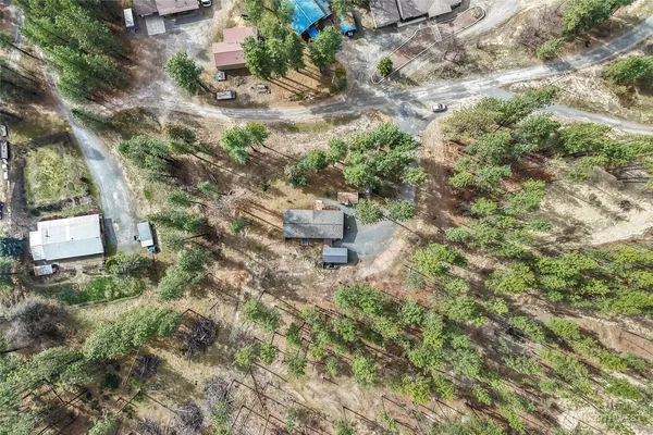 an aerial view of a house with a yard