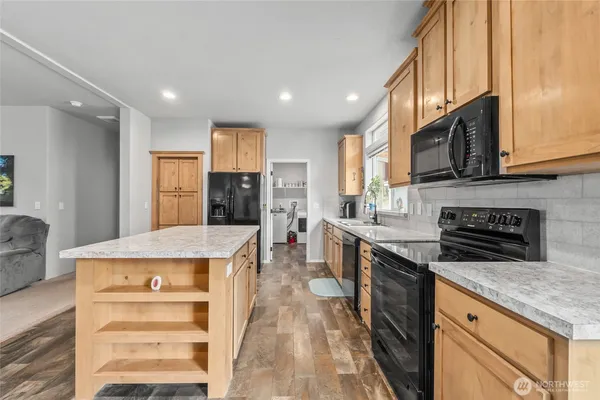a kitchen with stainless steel appliances granite countertop a stove and a refrigerator