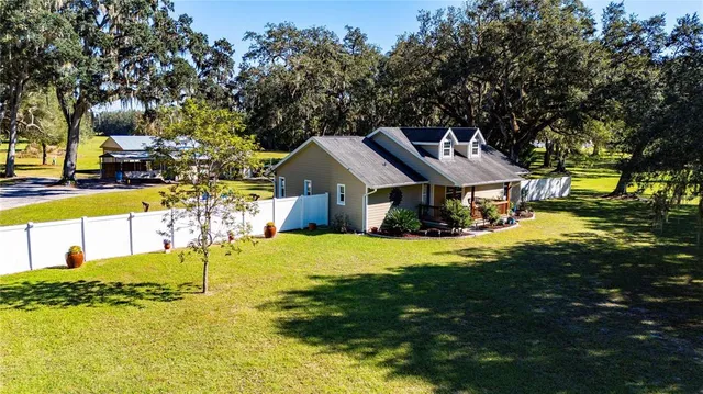 a front view of house with yard and trees