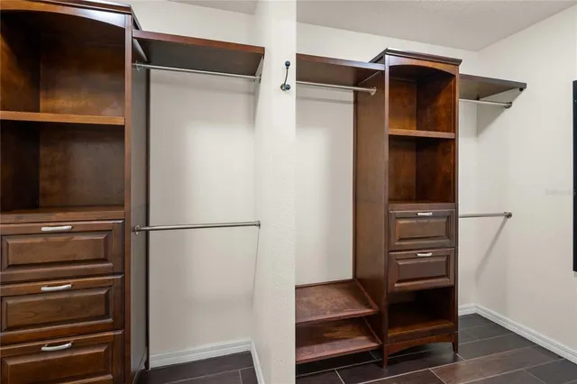 a kitchen with stainless steel appliances a dining table chairs refrigerator and sink