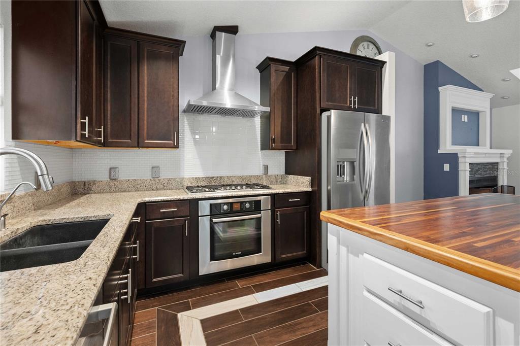 7037 County Road 625 Bushnell, FL 33513 - Photo 17 of 72 a kitchen with stainless steel appliances granite countertop a sink stove and refrigerator