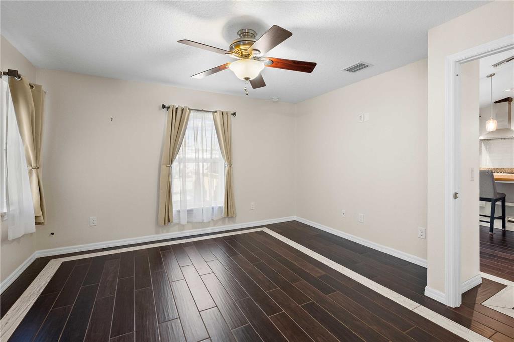 7037 County Road 625 Bushnell, FL 33513 - Photo 32 of 72 wooden floor in an empty room with a window