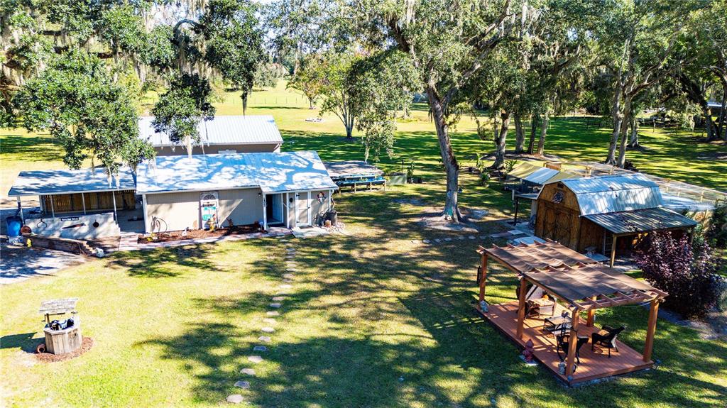 7037 County Road 625 Bushnell, FL 33513 - Photo 33 of 72 a view of a swimming pool with a patio and fire pit