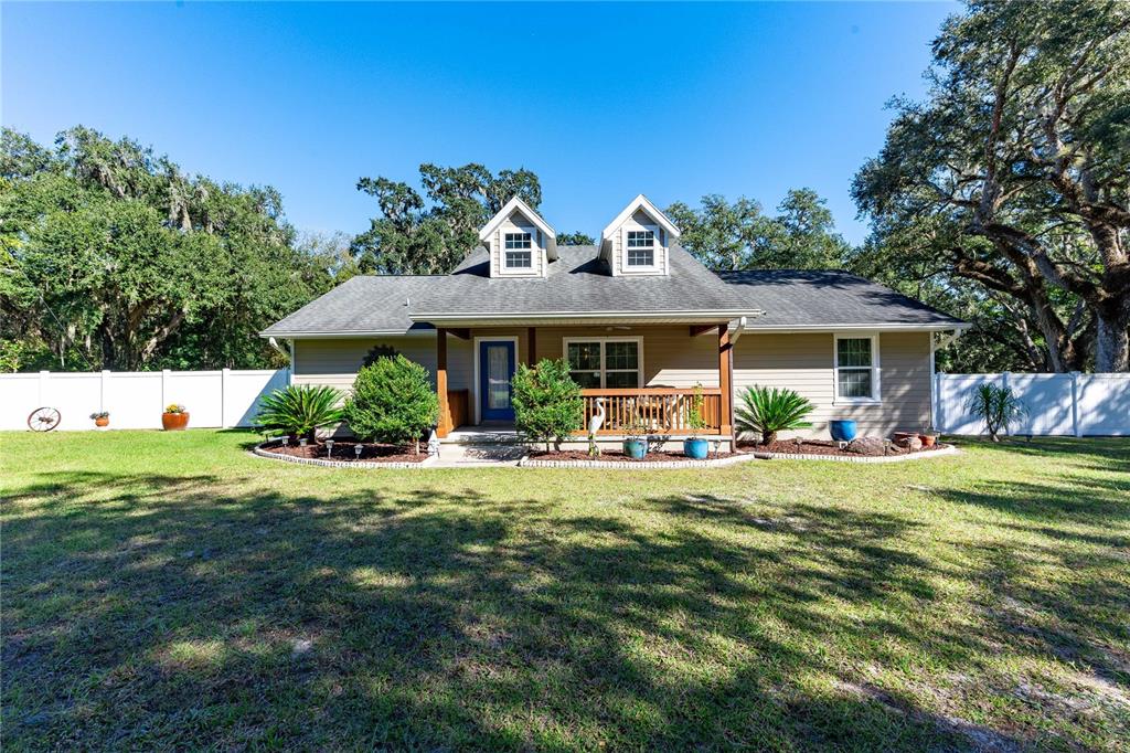 7037 County Road 625 Bushnell, FL 33513 - Photo 38 of 72 a view of a house with backyard porch and sitting area
