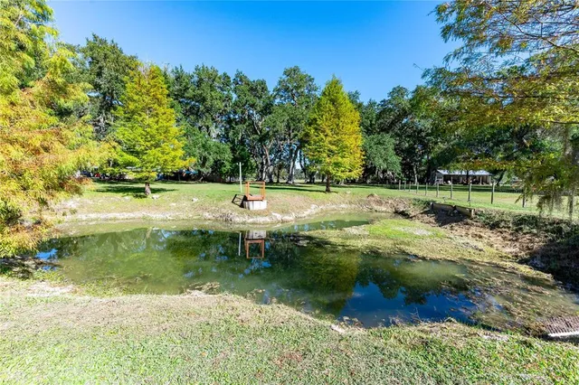 a view of a patio with table and chairs under an umbrella