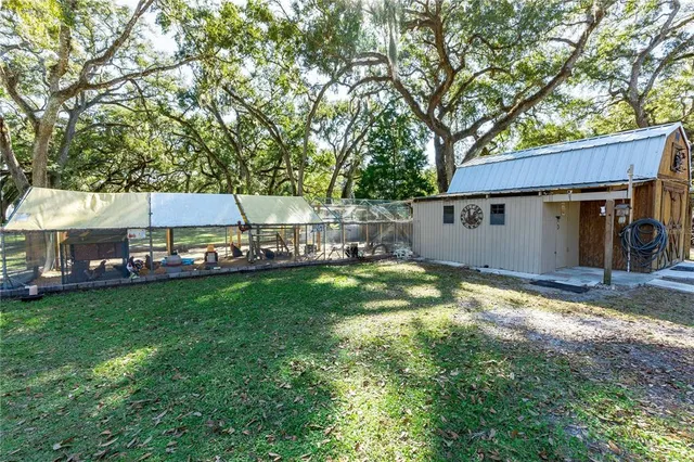 a view of swimming pool with outdoor seating and trees