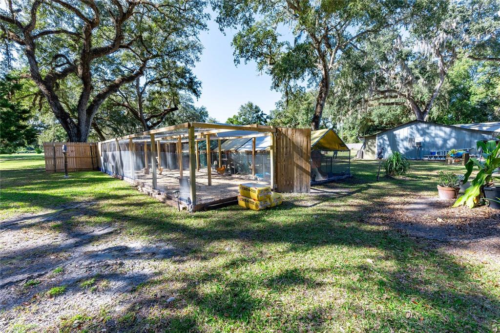 7037 County Road 625 Bushnell, FL 33513 - Photo 48 of 72 a view of a house with backyard and a patio