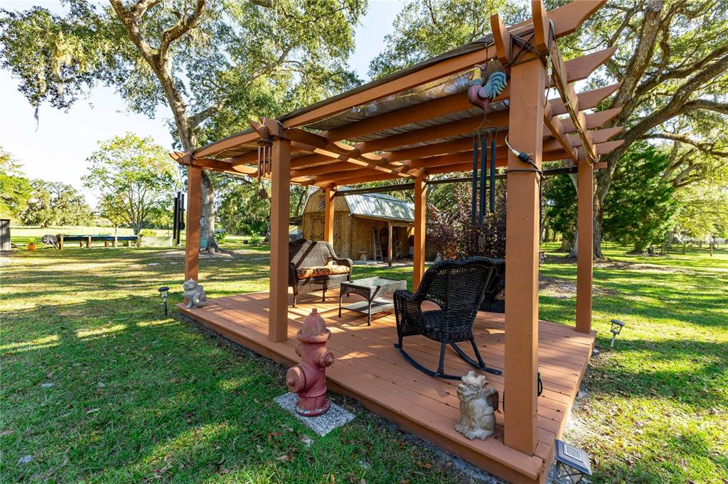 7037 County Road 625 Bushnell, FL 33513 - Photo 5 of 72 a view of a backyard with sitting area and furniture