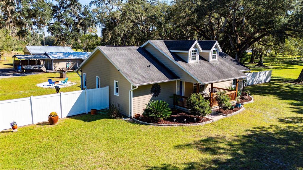 7037 County Road 625 Bushnell, FL 33513 - Photo 70 of 72 a view of a house with pool and chairs