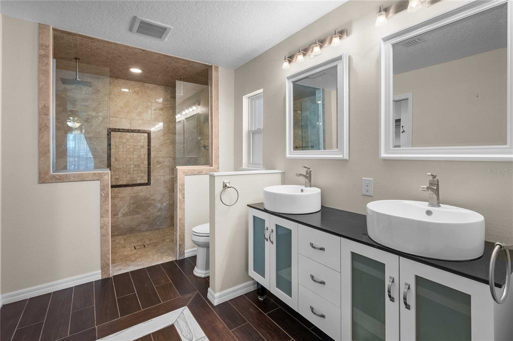 7037 County Road 625 Bushnell, FL 33513 - Photo 7 of 72 a bathroom with 2 sink and a mirror