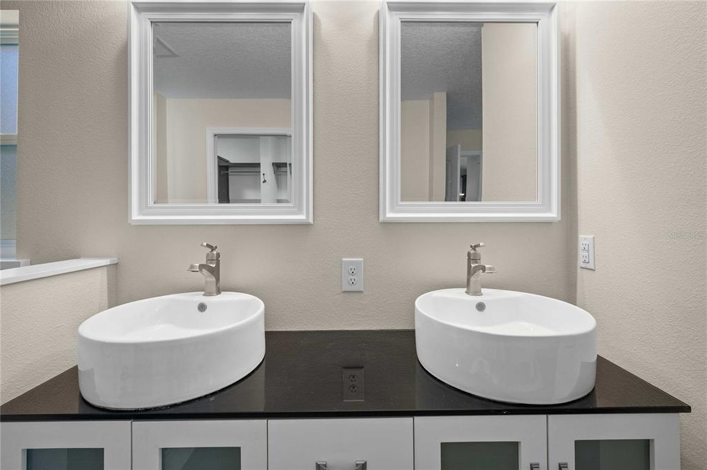 7037 County Road 625 Bushnell, FL 33513 - Photo 8 of 72 a bathroom with a sink and a mirror