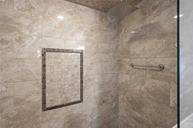 an empty room with wooden floor fireplace and windows