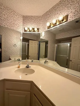a bathroom with a sink and a mirror